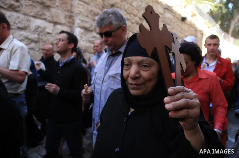 Christian Orthodox pilgrims participate in a procession marking Good Friday on April 18, 2014 in Jerusalem's old city. Thousands of Christian pilgrims take part in processions along the route where, according to traditio...