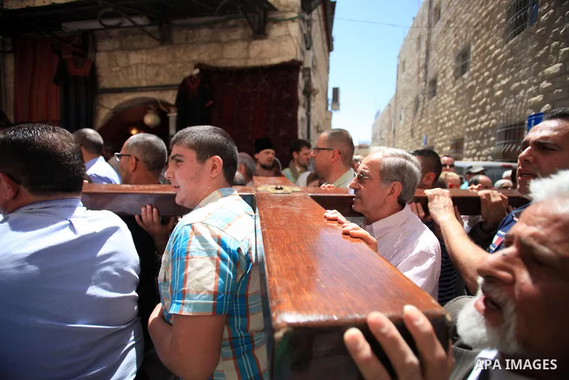 Christian Orthodox pilgrims participate in a procession marking Good Friday on April 18, 2014 in Jerusalem's old city. Thousands of Christian pilgrims take part in processions along the route where, according to traditio...