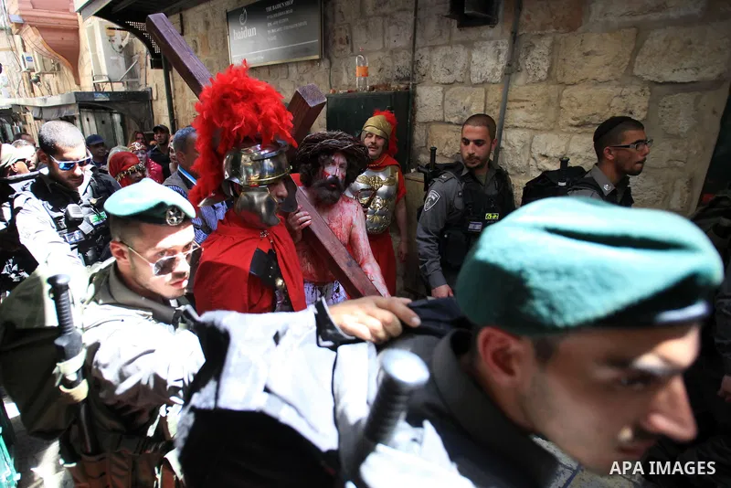 Christian Orthodox pilgrims participate in a procession marking Good Friday on April 18, 2014 in Jerusalem's old city. Thousands of Christian pilgrims take part in processions along the route where, according to traditio...
