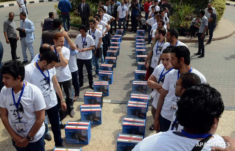 Campaign volunteers of presidential hopeful Hamdeen Sabahi, carry boxes containing thousands of endorsements at the election commission office in Cairo, Egypt, Saturday, April 19, 2014. It is mandatory for any presidenti...
