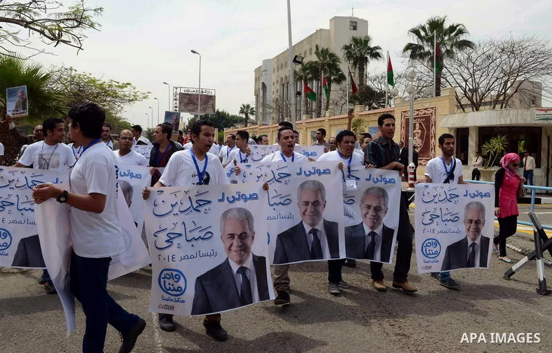 Campaign volunteers of presidential hopeful Hamdeen Sabahi, carry boxes containing thousands of endorsements at the election commission office in Cairo, Egypt, Saturday, April 19, 2014. It is mandatory for any presidenti...
