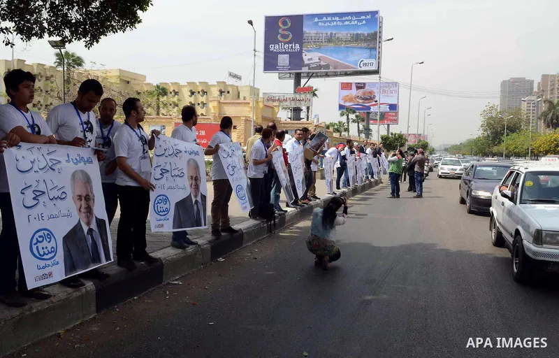 Campaign volunteers of presidential hopeful Hamdeen Sabahi, carry boxes containing thousands of endorsements at the election commission office in Cairo, Egypt, Saturday, April 19, 2014. It is mandatory for any presidenti...