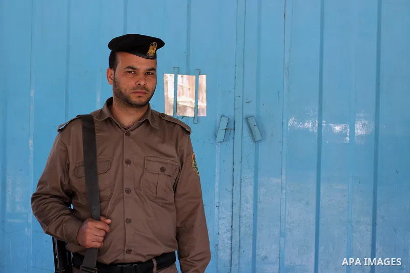 A Palestinian policeman guards during release of Palestinian Fatah member from a Palestinian prison in Gaza City April 21, 2014. Palestinian ministry of interior in Gaza freed 10 prisoners of the rival Fatah movement of...