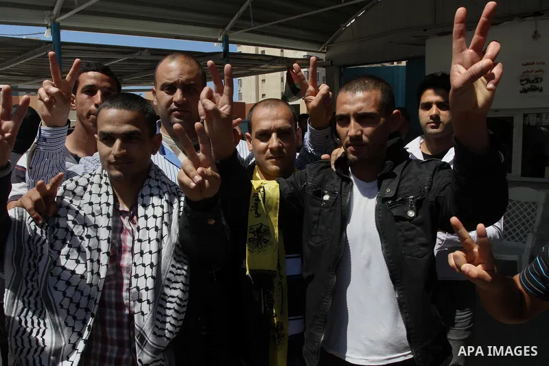 Palestinian Fatah member gestures after their release from a Palestinian prison in Gaza City April 21, 2014. Palestinian ministry of interior in Gaza freed 10 prisoners of the rival Fatah movement of President Mahmoud Ab...