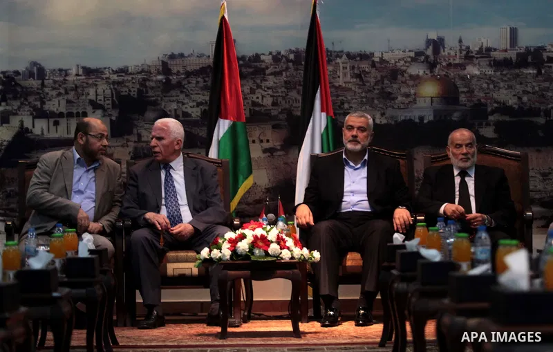 Hamas deputy leader Musa Abu Marzuk (L) speaks with the head of the delegation of the Palestine Liberation Organisation (PLO) Azzam al-Ahmad, a senior figure in the mainstream Fatah party of president Mahmud Abbas, durin...