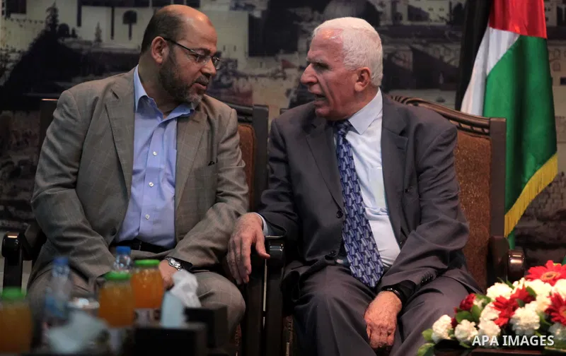 Hamas deputy leader Musa Abu Marzuk (L) speaks with the head of the delegation of the Palestine Liberation Organisation (PLO) Azzam al-Ahmad, a senior figure in the mainstream Fatah party of president Mahmud Abbas, durin...