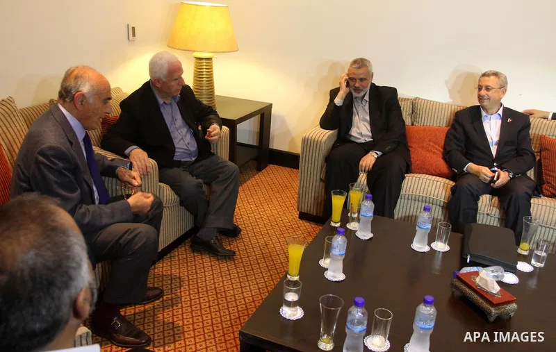 Palestinian Prime Minister in Gaza Strip Ismail Haniya speaks on the phone during a meeting with Palestinian Fatah delegation chief Azzam al-Ahmed the day after rival Palestinian leaders from the West Bank and Gaza Strip...
