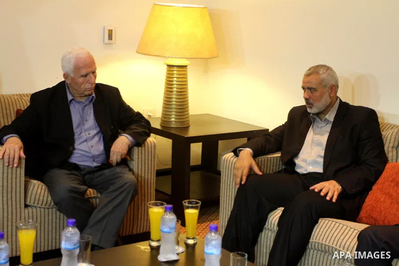 Palestinian Prime Minister in Gaza Strip Ismail Haniya (R) speaks with Palestinian Fatah delegation chief Azzam al-Ahmed during a meeting the day after rival Palestinian leaders from the West Bank and Gaza Strip agreed t...