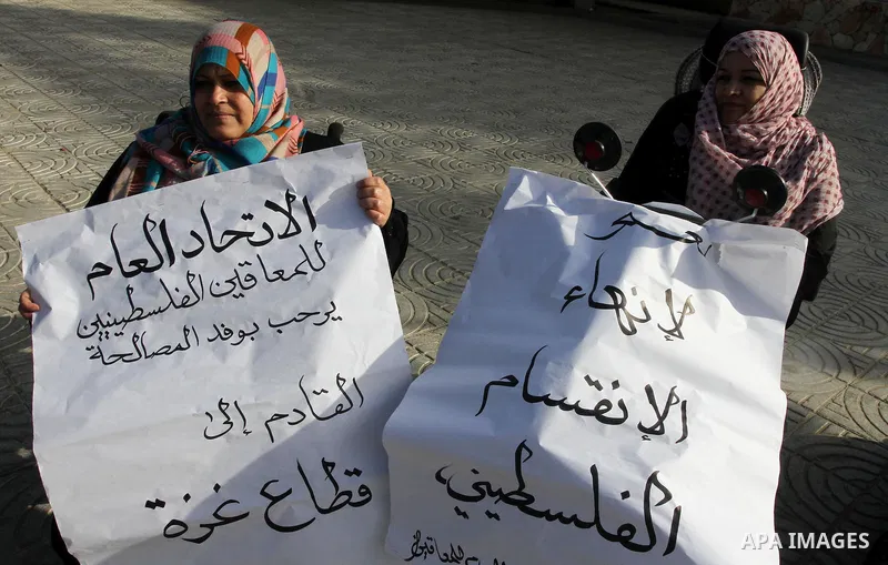 Palestinians with special needs take part in celebrate the agreement to form a unity government in Gaza city on April 24, 2014. The agreement was reached on April 23, in talks in Gaza City which continued into the early...