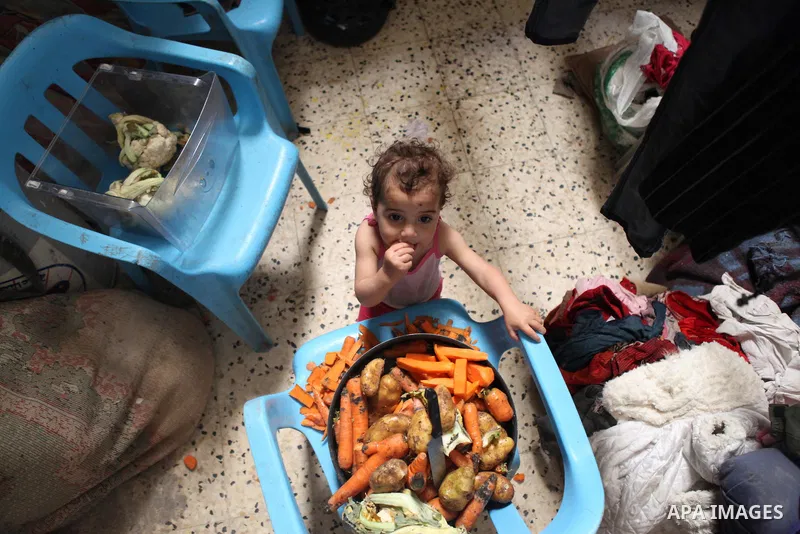 A Palestinian girl plays inside her house in Kafr near the West Bank city of Ramallah April 25, 2014. Al-Kurdi poor family consist of 8 members who face difficult life and the high cost of living. Photo by Shadi Hatem