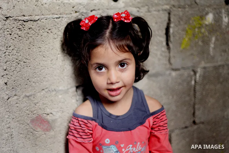 A Palestinian girl plays inside her house in Kafr near the West Bank city of Ramallah April 25, 2014. Al-Kurdi poor family consist of 8 members who face difficult life and the high cost of living. Photo by Shadi Hatem