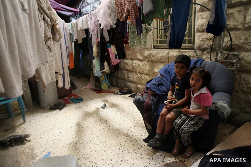 Palestinian children play inside their house in Kafr near the West Bank city of Ramallah April 25, 2014. Al-Kurdi poor family consist of 8 members who face difficult life and the high cost of living. Photo by Shadi Hatem