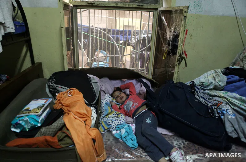 A Palestinian girl sits inside her house in Kafr near the West Bank city of Ramallah April 25, 2014. Al-Kurdi poor family consist of 8 members who face difficult life and the high cost of living. Photo by Shadi Hatem