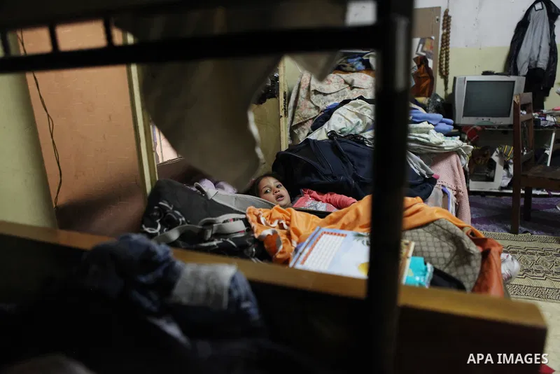 A Palestinian girl sits inside her house in Kafr near the West Bank city of Ramallah April 25, 2014. Al-Kurdi poor family consist of 8 members who face difficult life and the high cost of living. Photo by Shadi Hatem