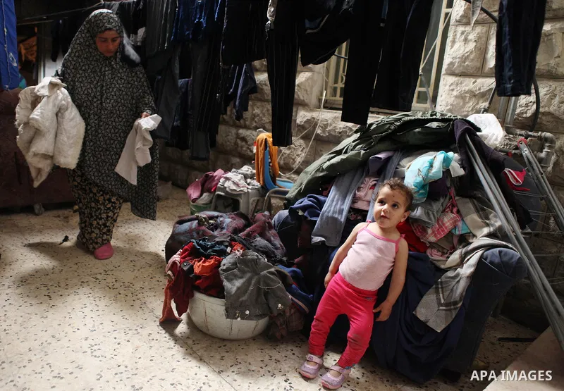A Palestinian woman and her daughter inside their house in Kafr near the West Bank city of Ramallah on April 25, 2014. Al-Kurdi poor family consist of 8 members who face difficult life and the high cost of living. Photo...