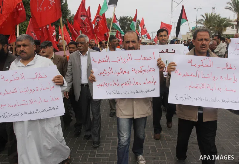 Supporters of Democratic Front for the Liberation of Palestine shout slogans as they take part in a demonstration in support of a new attempt to reconcile the militant Islamist movement Hamas and its Palestine Liberation...