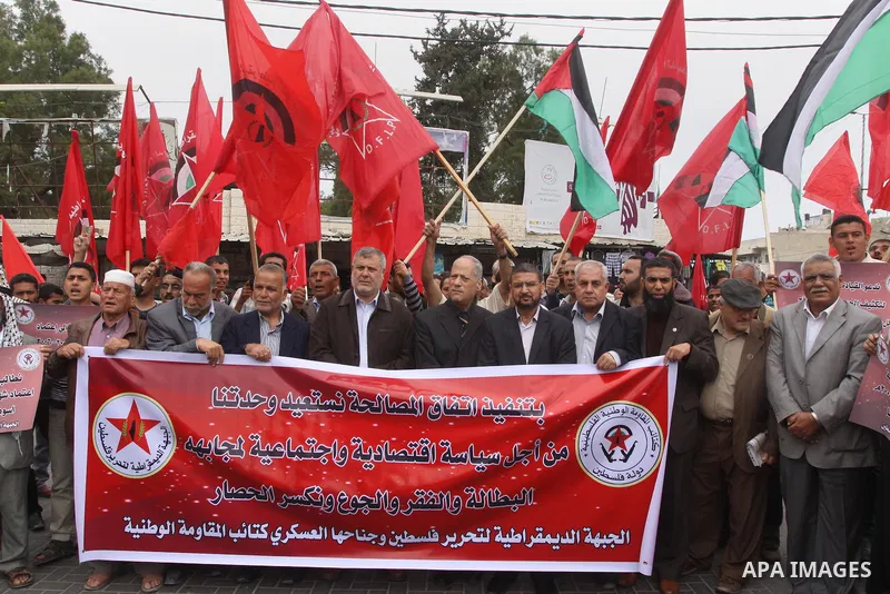 Supporters of Democratic Front for the Liberation of Palestine shout slogans as they take part in a demonstration in support of a new attempt to reconcile the militant Islamist movement Hamas and its Palestine Liberation...