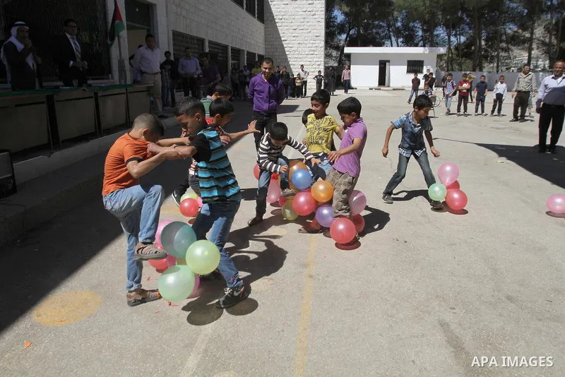 Palestinian children participate in the open day at school in the West Bank city of Nablus on April 27, 2014. Photo by Nedal Eshtayah