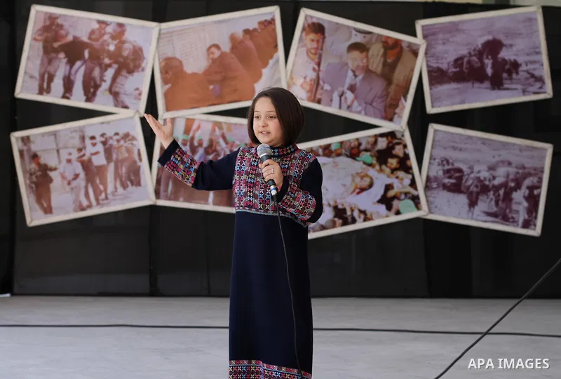 A Palestinian girl attends a Photo Gallery at Islamic University in Gaza city, on April 27, 2014. Photo by Mohammed Asad