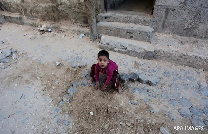 A Palestinian boy plays outside his family's house at Shati refugee camp, in Gaza City on April 27, 2014. The Israeli prime minister, Binyamin Netanyahu, accused the western-backed Palestinian president, Mahmoud Abbas, o...