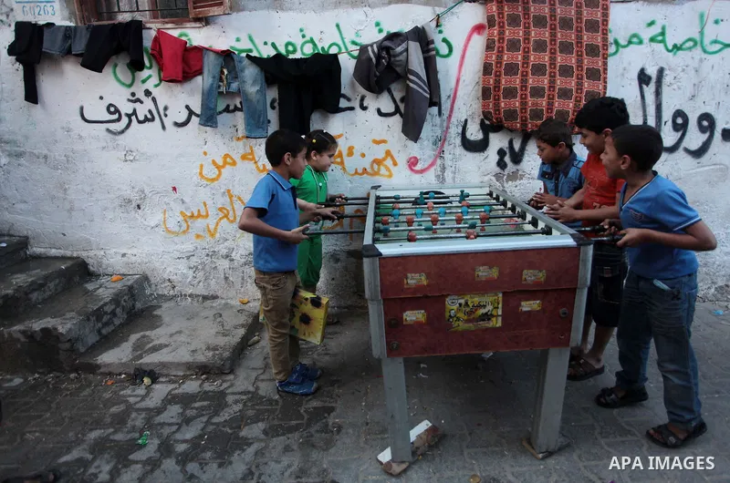 Palestinian children play table football at Shati refugee camp, in Gaza City on April 27, 2014. The Israeli prime minister, Binyamin Netanyahu, accused the western-backed Palestinian president, Mahmoud Abbas, of forming...