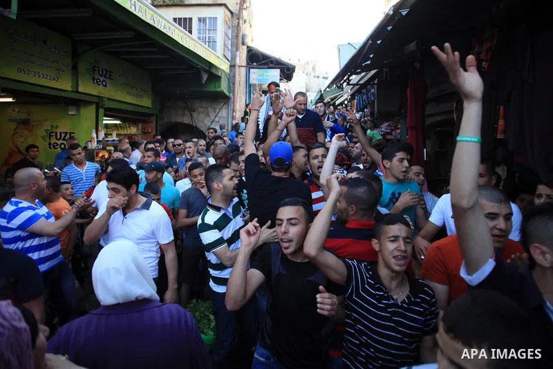 Palestinians celebrate the release of protesters detained by Israeli police during recent clashes at the Al-Aqsa mosque compound on April 27, 2014 in the Old City of Jerusalem. Israeli police arrested 16 Palestinians las...