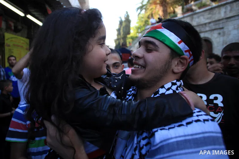 Palestinians celebrate the release of protesters detained by Israeli police during recent clashes at the Al-Aqsa mosque compound on April 27, 2014 in the Old City of Jerusalem. Israeli police arrested 16 Palestinians las...
