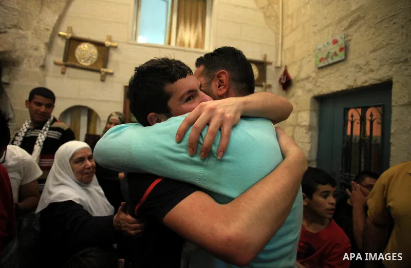 Palestinians celebrate the release of protesters detained by Israeli police during recent clashes at the Al-Aqsa mosque compound on April 27, 2014 in the Old City of Jerusalem. Israeli police arrested 16 Palestinians las...