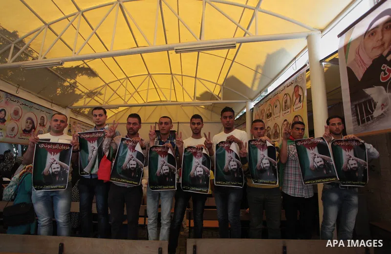 Palestinian youths take part in a protest demanding the release of their relatives prisoners held in Israeli jails, in front of the Red Cross office in Gaza City, on April 28, 2014. Photo by Ashraf Amra