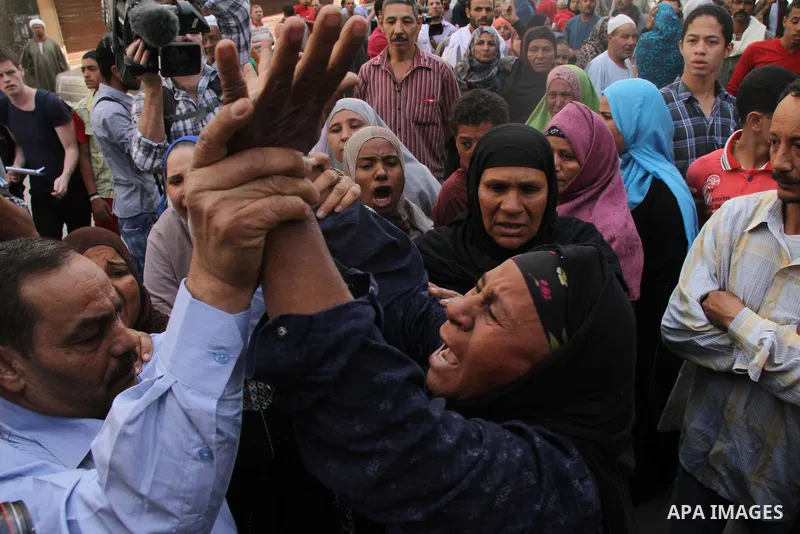 Relatives and families of members of Muslim Brotherhood and supporters of ousted President Mohamed Mursi react after hearing the sentence, in front of the court in Minya, south of Cairo, April 28, 2014. An Egyptian court...