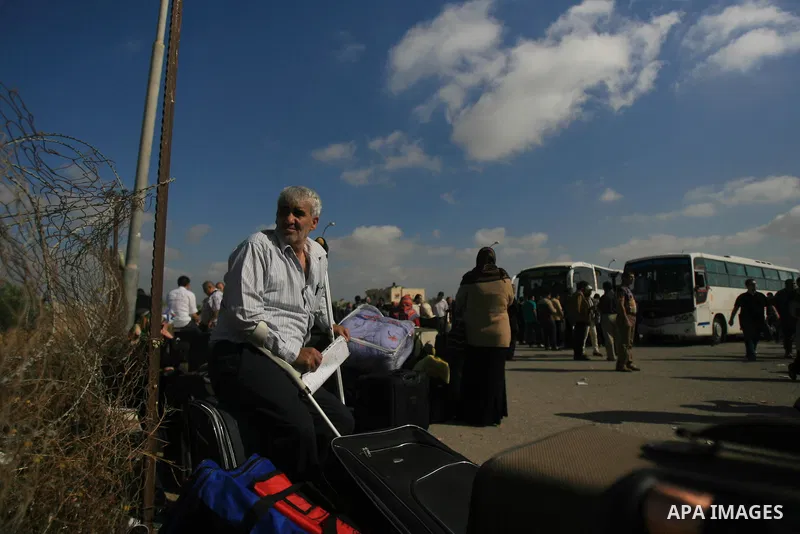 Palestinians hoping to cross into Egypt wait at the Rafah crossing between Egypt and the southern Gaza Strip April 29, 2014. Egyptian authorities opened Rafah crossing on Tuesday and Wednesday to allow medical and humani...