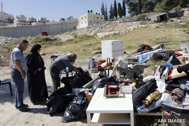 Palestinians inspect their belongings following demolished their sheds by Israeli bulldozers, in al-Tour neighborhood, east Jerusalem on April 29, 2014. Israeli forces accompanied by bulldozers, stormed Al-Hardub neighbo...