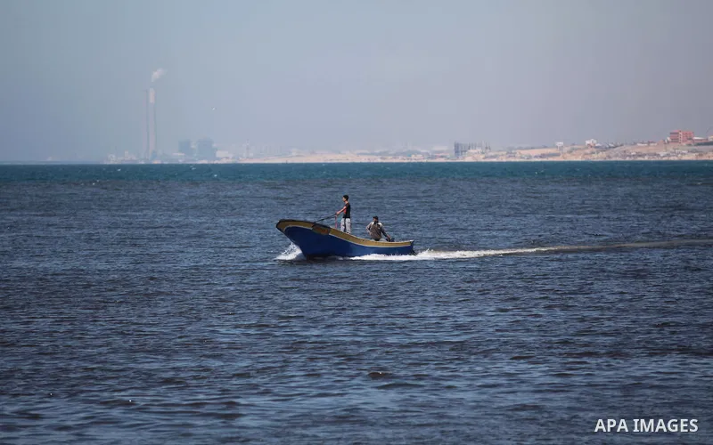 A Palestinian man inspects the Gaza's Ark, a Palestinian-built protest boat which was preparing to run Israel's naval blockade, after it was damaged in an explosion at the port in Gaza City, on April 29, 2014. The blast...