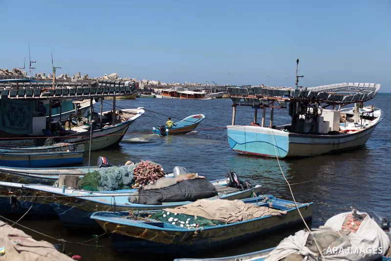 A Palestinian man inspects the Gaza's Ark, a Palestinian-built protest boat which was preparing to run Israel's naval blockade, after it was damaged in an explosion at the port in Gaza City, on April 29, 2014. The blast...