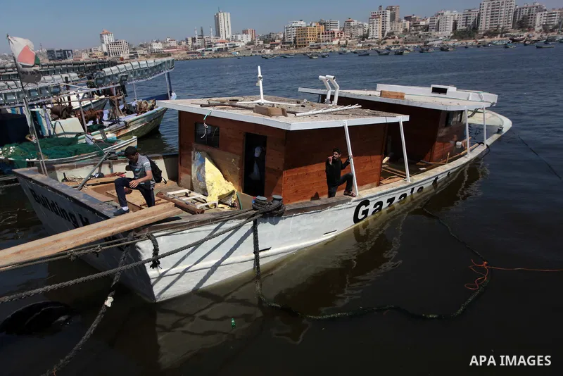 Palestinians inspect the Gaza's Ark, a Palestinian-built protest boat which was preparing to run Israel's naval blockade, after it was damaged in an explosion at the port in Gaza City, on April 29, 2014. The blast occurr...