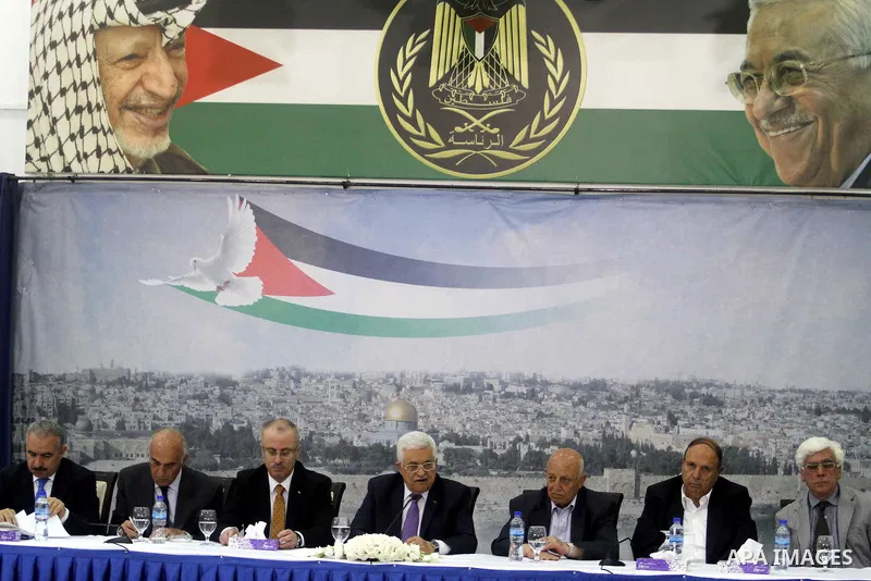 Palestinian President Mahmoud Abbas attends a meeting of Palestinian businessmen from East Jerusalem to set up a national fund to support the Palestinian residents of East Jerusalem, at his office in the West Bank town o...