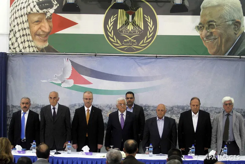 Palestinian President Mahmoud Abbas attends a meeting of Palestinian businessmen from East Jerusalem to set up a national fund to support the Palestinian residents of East Jerusalem, at his office in the West Bank town o...