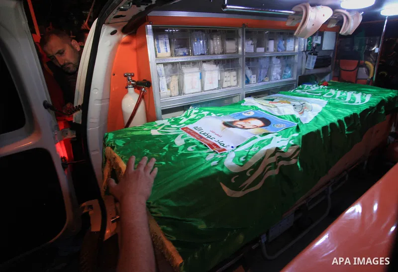 Palestinians carry coffins of two Hamas members Adel and Imad Awadallah, killed in 1998, after their remains were returned from Israel in the early hours of April 30, 2014 in the West Bank city of Al-Bireh. Israel return...