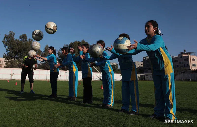 Palestinian girls take part in a training session at the Beit Lahia football club in the northern Gaza strip, on April 30, 2014 as part of an after-school sport program funded by the Palestine Association for Children s...