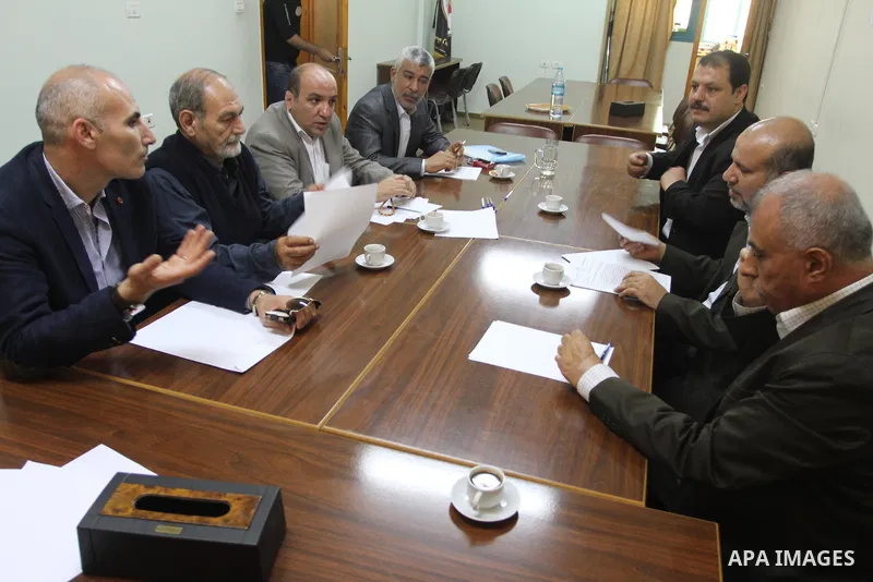 Members of the Freedoms Committee, which includes Fatah, Hamas and others Palestinian movements, meet to follow up the implementation of the reconciliation steps, in Gaza City, on April 30, 2014. Israeli cabinet minister...
