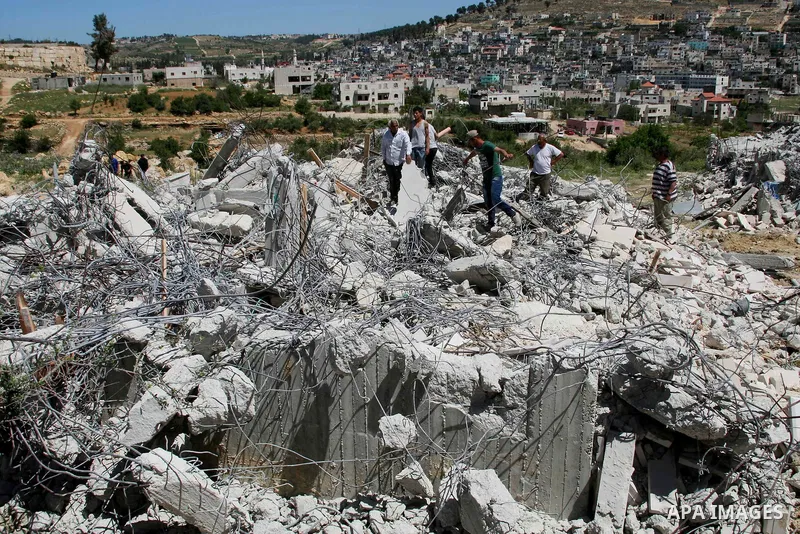 Palestinians inspect the rubble of a house under construction after it was demolished by Israeli bulldozers in Al-Aroub refugee camp, near the West Bank City of Hebron April 30, 2014. Israeli military said that "security...