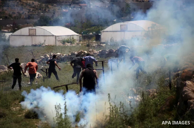 Palestinian protestors throw stones towards members of the Israeli security forces during clashes in Al-Aroub refugee camp, near the West Bank City of Hebron April 30, 2014. Israeli military said that "security forces ca...