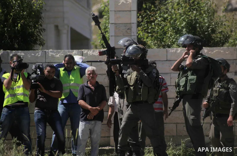 Israeli security forces fire tear gas at Palestinian protestors during clashes in Al-Aroub refugee camp, near the West Bank City of Hebron April 30, 2014. Israeli military said that "security forces carried out the demol...