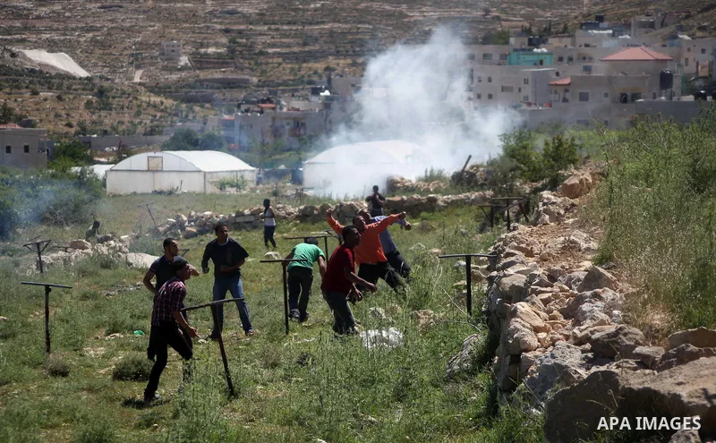 Palestinian protestors throw stones towards members of the Israeli security forces during clashes in Al-Aroub refugee camp, near the West Bank City of Hebron April 30, 2014. Israeli military said that "security forces ca...