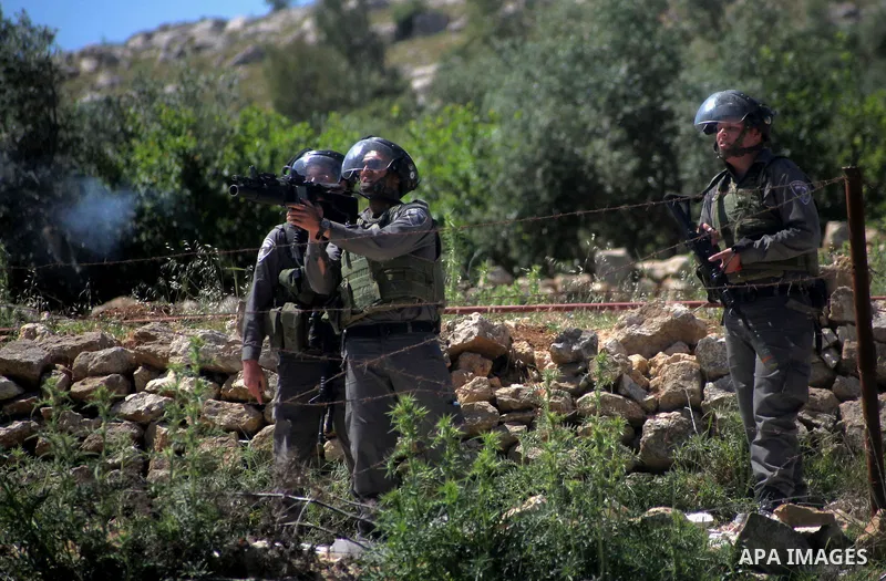Israeli security forces fire tear gas at Palestinian protestors during clashes in Al-Aroub refugee camp, near the West Bank City of Hebron April 30, 2014. Israeli military said that "security forces carried out the demol...