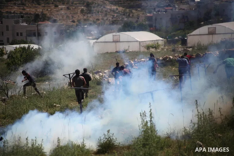 Palestinian protestors throw stones towards members of the Israeli security forces during clashes in Al-Aroub refugee camp, near the West Bank City of Hebron April 30, 2014. Israeli military said that "security forces ca...