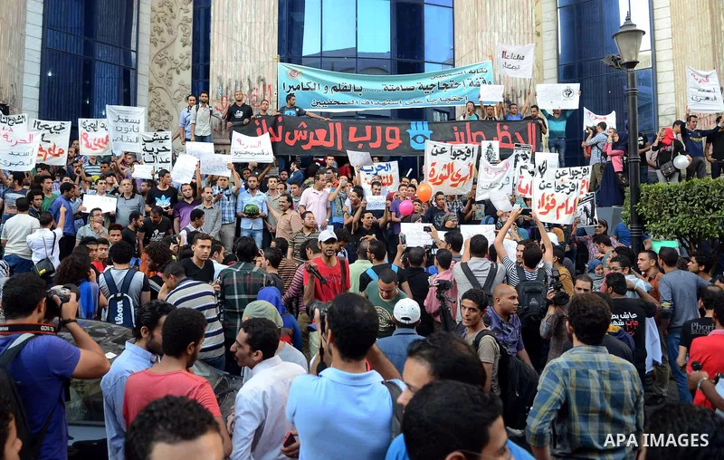Members of the April 6 movement and liberal activists hold placards and shout slogans during a demonstration outside the Journalists Syndicate, in Cairo on April 30, 2014. The April 6 youth movement has vowed to keep ope...