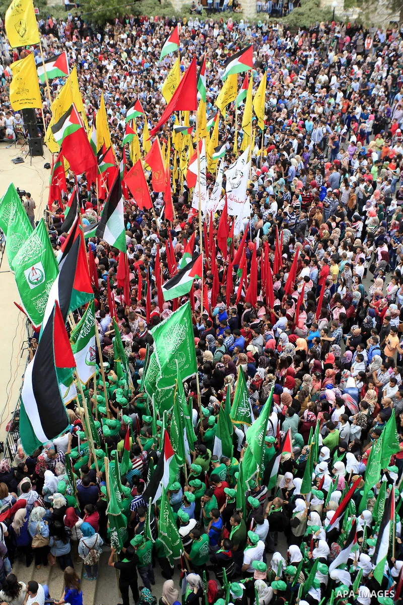 Palestinian supporters of the Islamic Hamas movement and Fatah movement attend a rally prior to the Student Council elections at Birzeit University, on the outskirts of the city of Ramallah in the West Bank on May 6, 201...