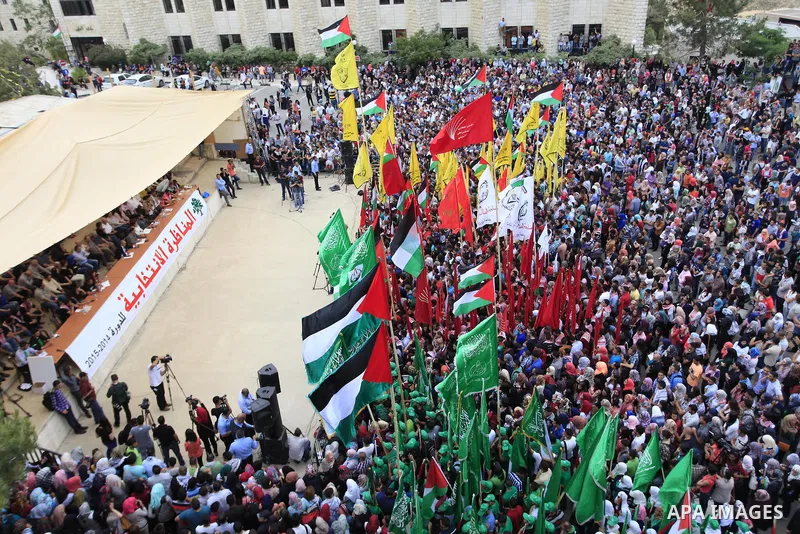 Palestinian supporters of the Islamic Hamas movement and Fatah movement attend a rally prior to the Student Council elections at Birzeit University, on the outskirts of the city of Ramallah in the West Bank on May 6, 201...