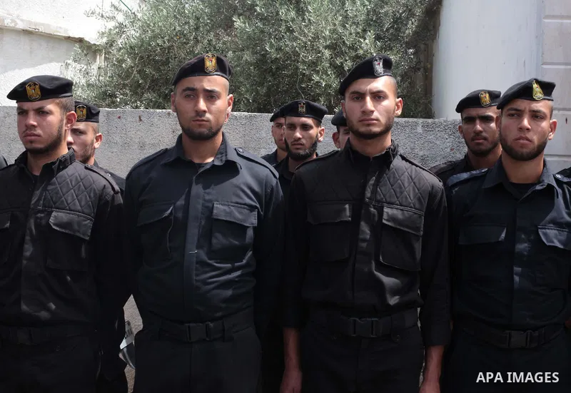 Palestinian policemen stand guard in front of the United Nations Development Programme office (UNDP), during a protest calling for the release of Palestinian prisoners from Israeli jails, in Gaza City on May 07, 2014. Ph...